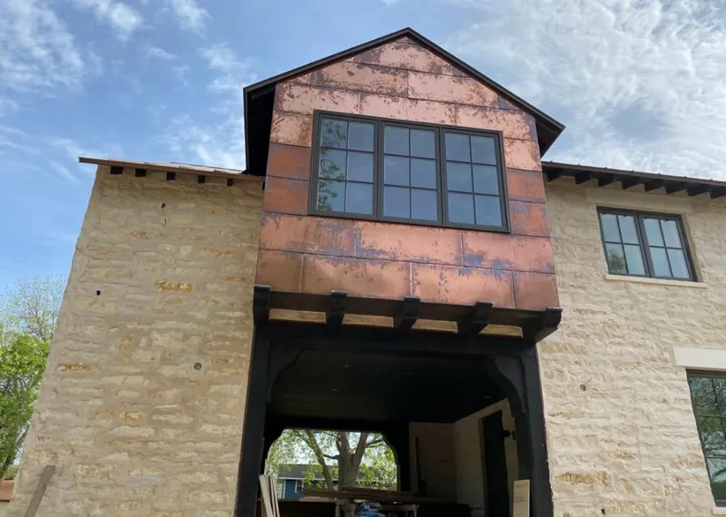 Copper metal panel facade on a stone building for Skylight Installation in Tyler