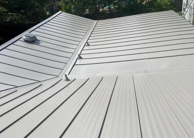 Solar attic fan installed on a metal roof for Roof Ventilation in Tyler